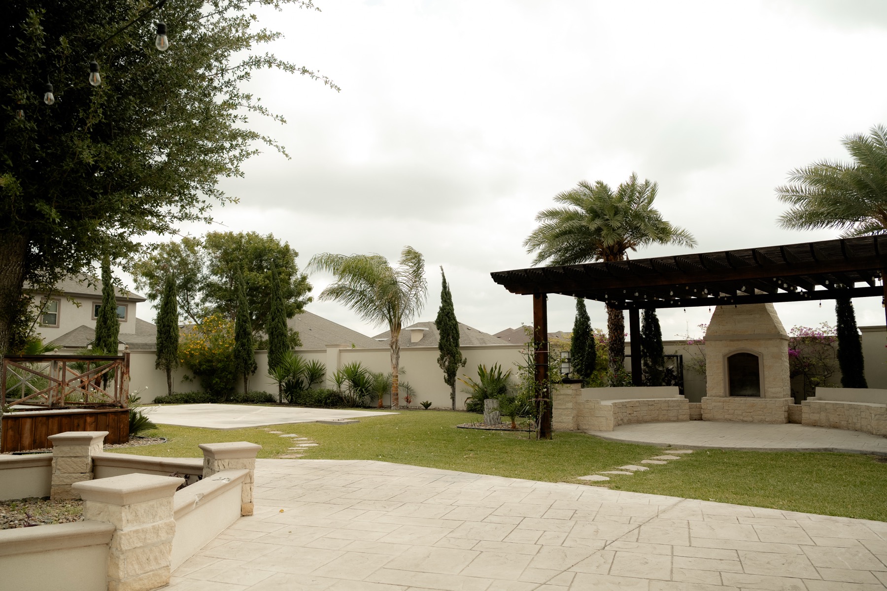 Open lawn with pergola and fireplace