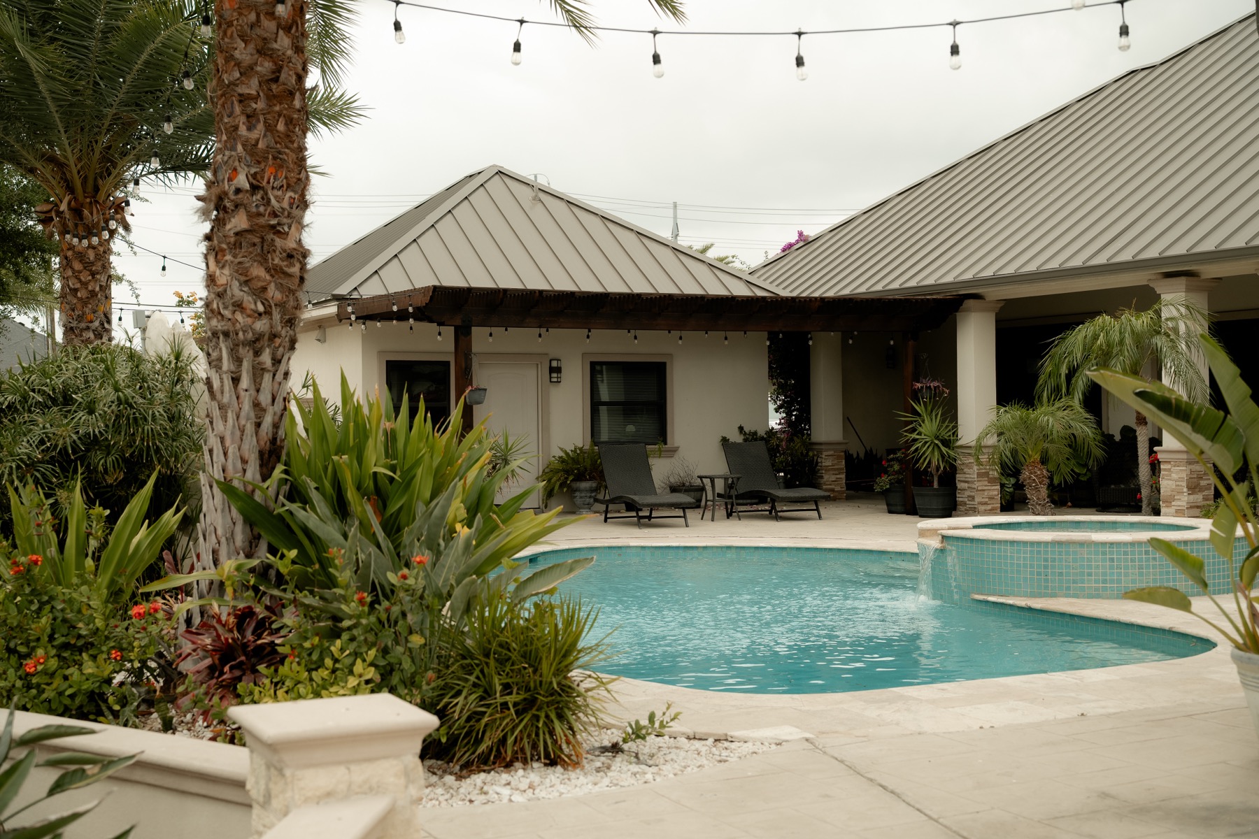 Poolside patio strung with evening lights