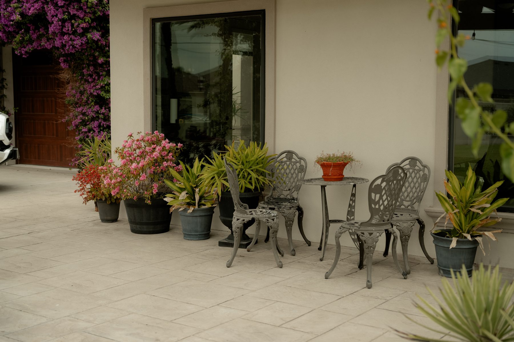 Cast iron patio seating with flowering plants